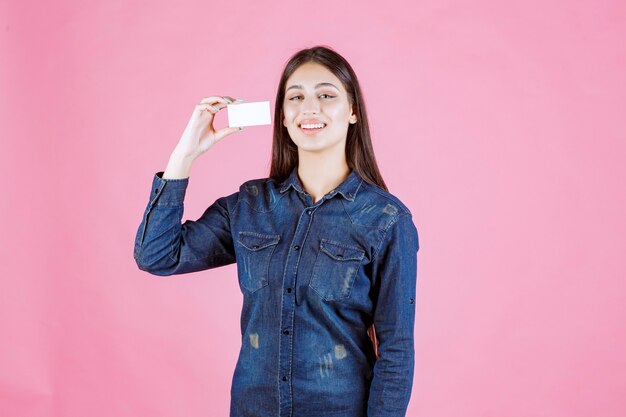 Businesswoman holding and presenting her new business card