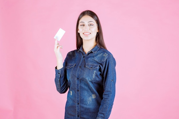 Businesswoman holding and presenting her new business card