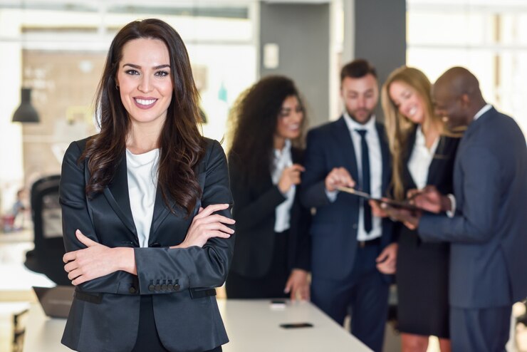 Free Photo businesswoman leader in modern office with businesspeople workin