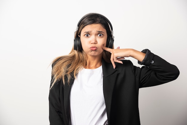 Businesswoman listening music in headphones . 