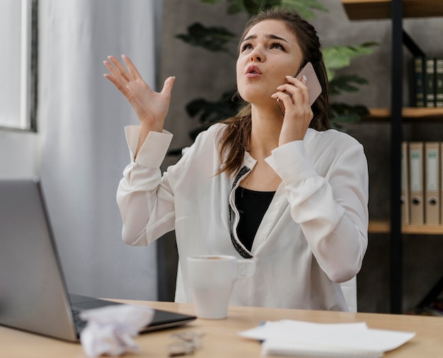 Businesswoman looking frustrated while having a call