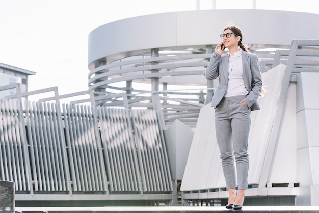 Free photo businesswoman making phone call outdoors
