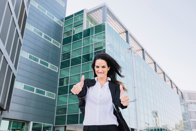 Businesswoman making thumbs up gesture