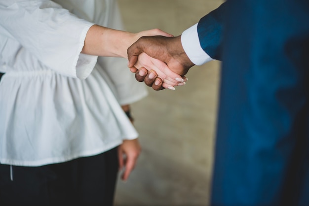 Businesswoman and man handshake