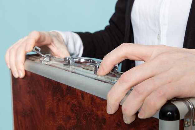 Businesswoman opens suitcase