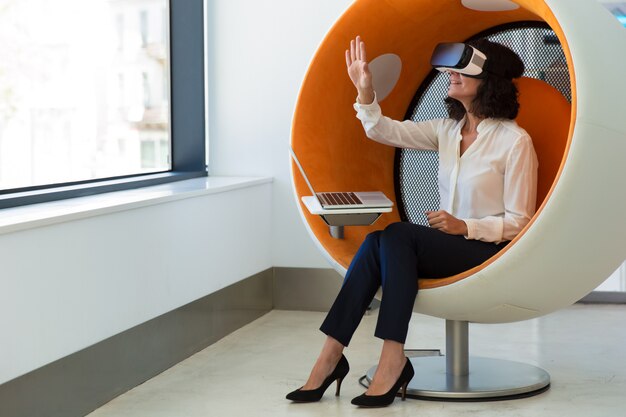 Businesswoman playing virtual game in studio