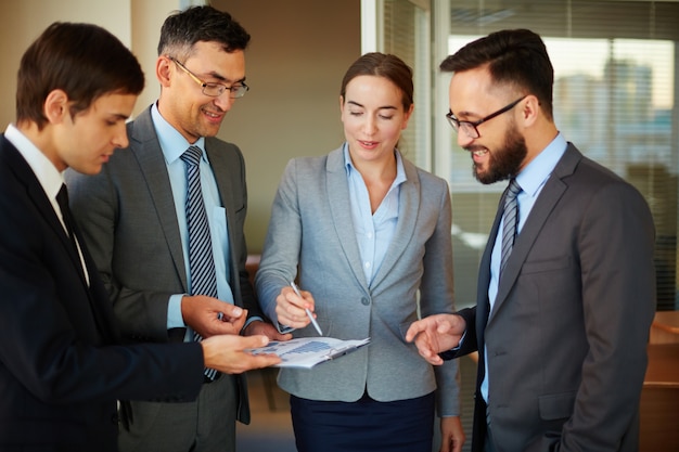 Businesswoman pointing to a chart with pen