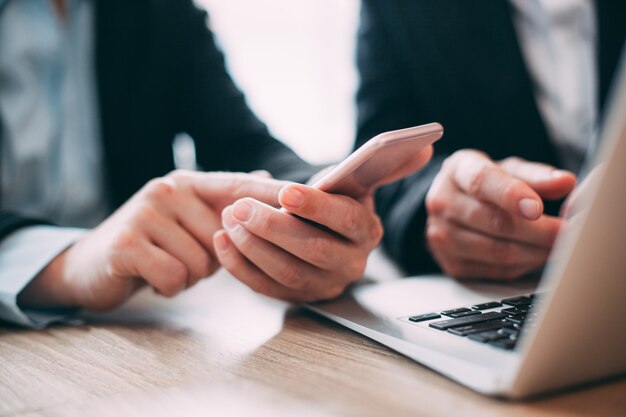 Businesswoman reading message on mobile phone