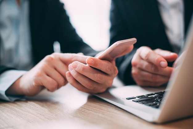 Businesswoman reading message on mobile phone