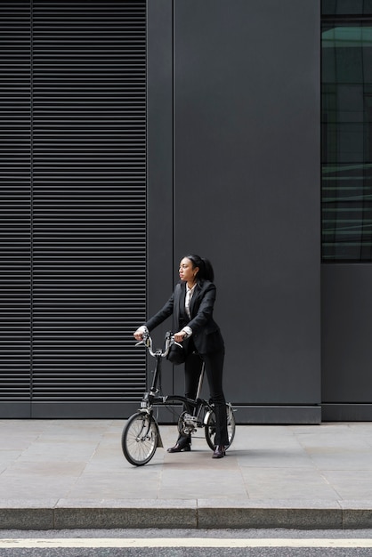 Free photo businesswoman riding a bike