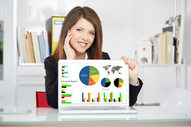 Businesswoman show financial report on laptop in office