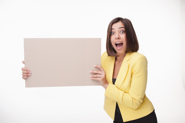 Businesswoman showing board or banner with copy space on white background