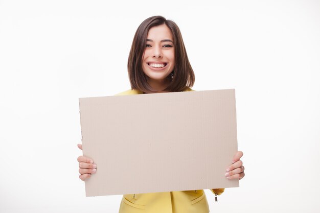 Businesswoman showing board or banner with copy space on white