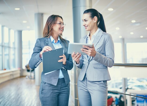 Businesswoman showing a news on her tablet