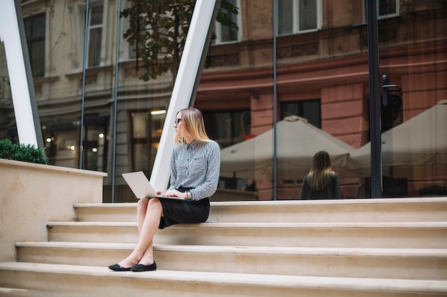 Businesswoman sit at the stairs