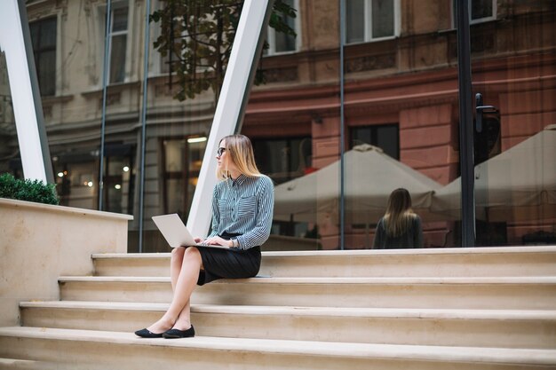 Businesswoman sit at the stairs