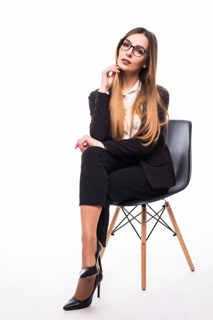 Businesswoman sitting on a black chair on white