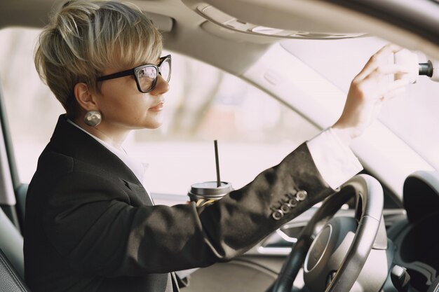 車の中に座っている実業家とコーヒーを飲む