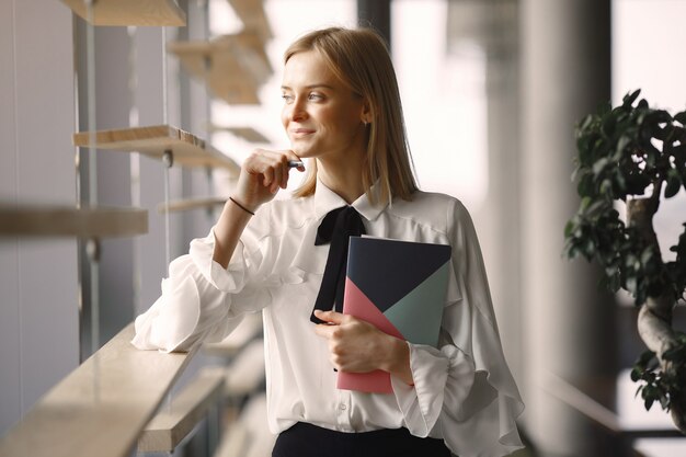 Businesswoman sitting at the table with a notebook