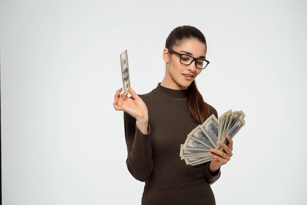 Businesswoman smiling pleased at money