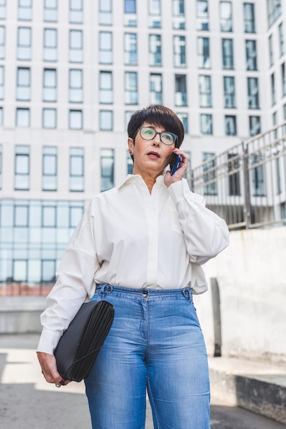 Businesswoman standing in front of big building