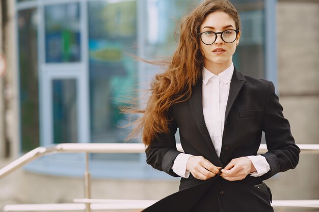 Businesswoman standing outdoors in city office building 