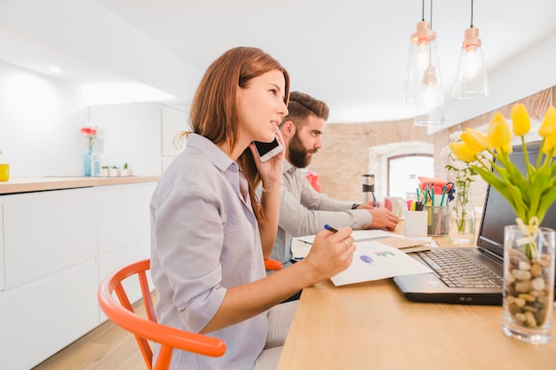 Businesswoman talking phone in office