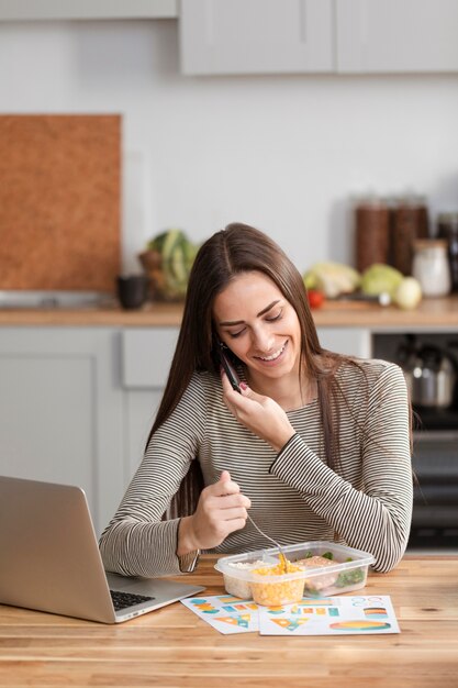 Businesswoman trying to eat and work