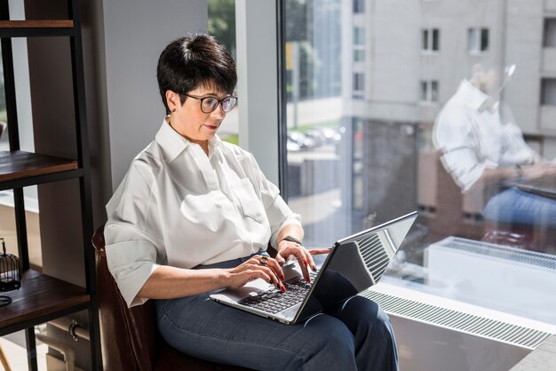 Businesswoman typing on her laptop