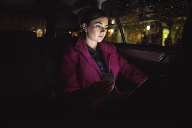 Businesswoman using digital tablet and phone