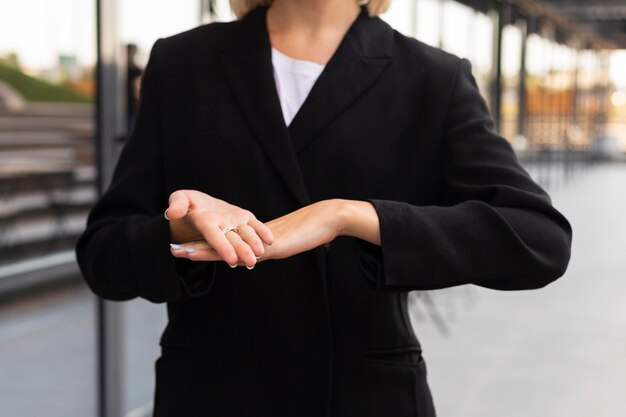 Businesswoman using sign language outdoors at work