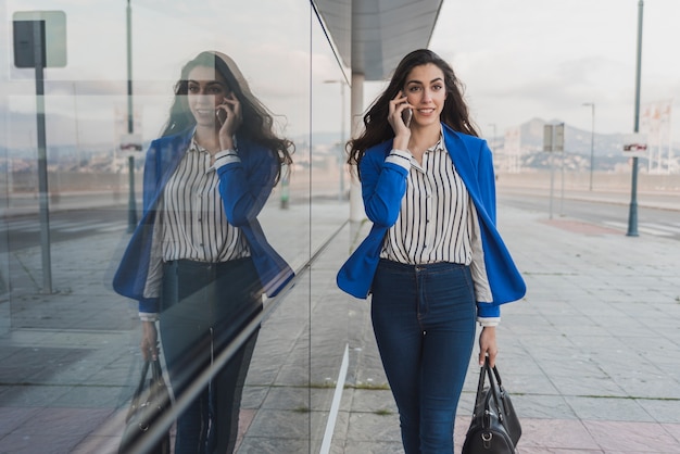 Businesswoman walking while talking on the phone