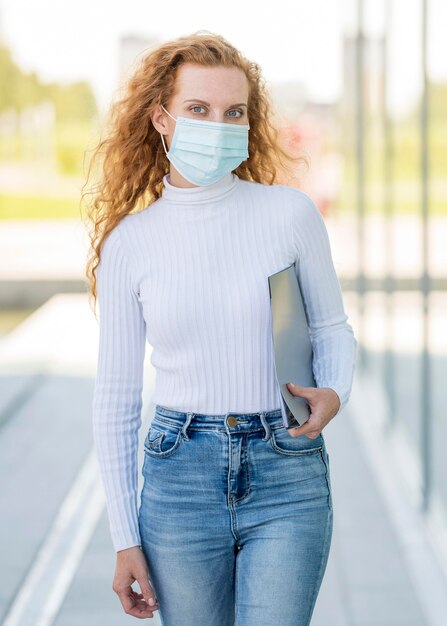 Businesswoman wearing medical mask outdoors