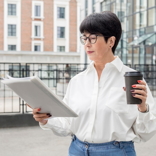 Businesswoman wearing reading glasses medium shot