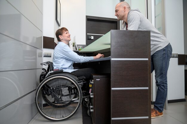 Businesswoman in wheelchair and man long view