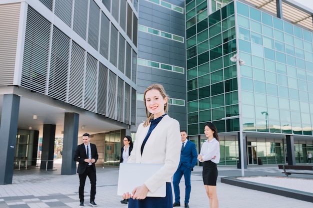 Businesswoman with business team behind