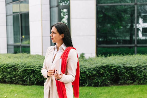 Businesswoman with diary standing outside office