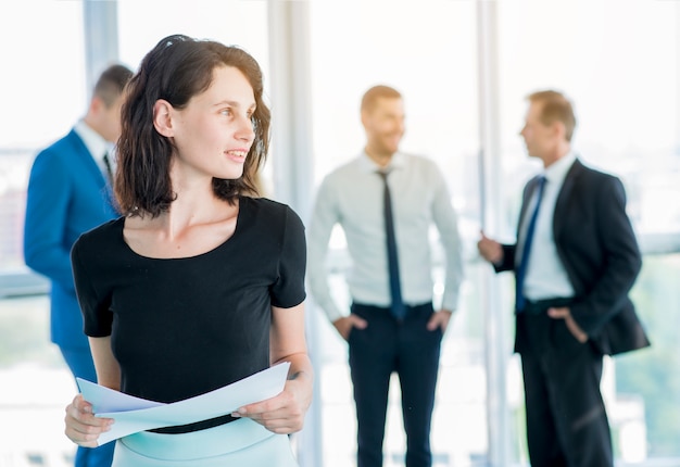 Businesswoman with documents looking away