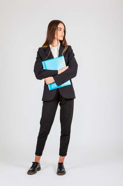 Businesswoman with folder on natural pose