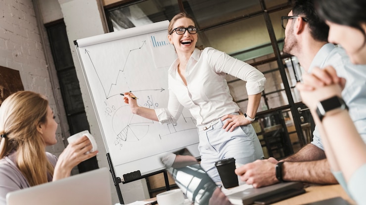 Free Photo businesswoman with glasses during a meeting presentation with her team