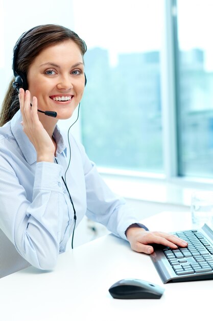 Businesswoman with headset talking to someone online