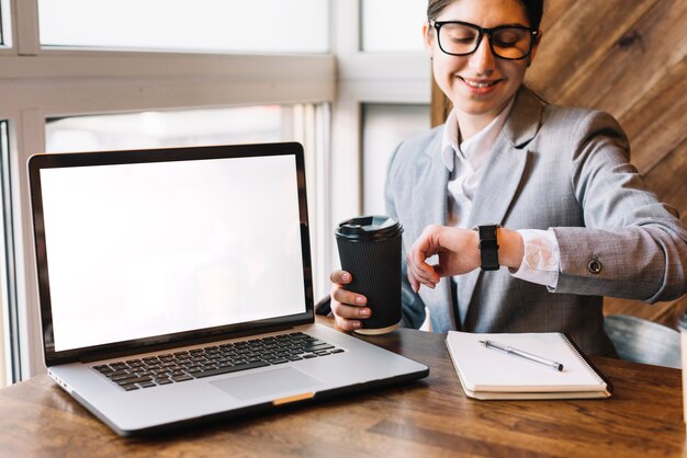 Businesswoman with laptop in coffee shop