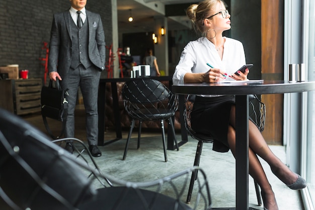 Businesswoman working on document in restaurant