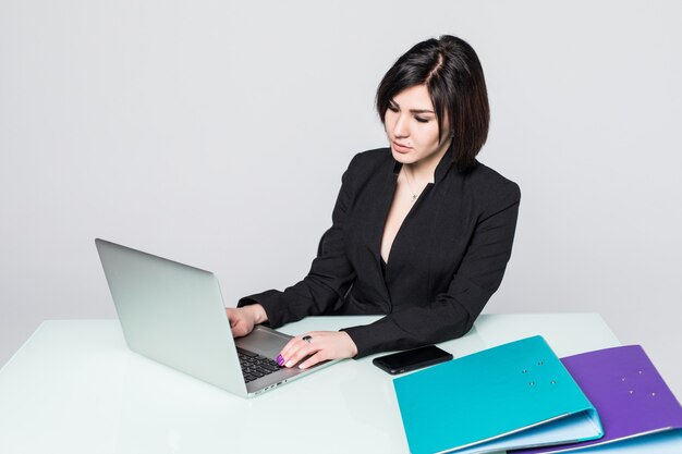 Businesswoman working on laptop computer at office desk