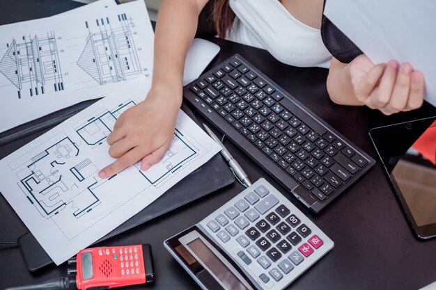 Businesswoman working in the office with a smile while sitting.