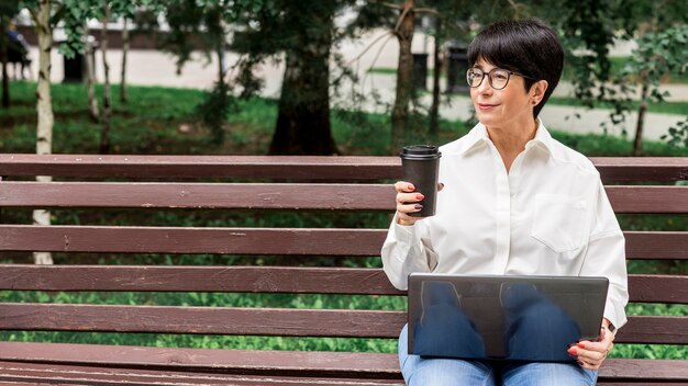 Businesswoman working outdoors copy space