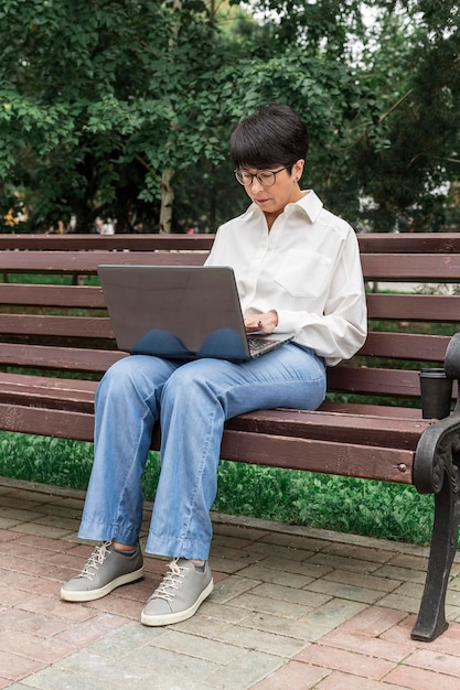 Businesswoman working outdoors long view