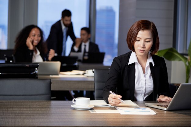 Businesswoman working with document in office