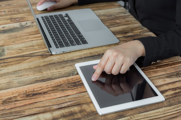 Businesswoman working with laptop and tablet