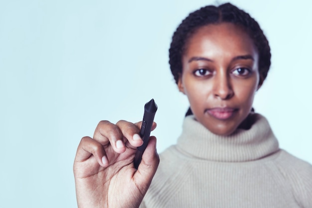 Businesswoman writing invisible screen with stylus